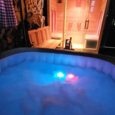 The wellness area features a jacuzzi and a sauna.